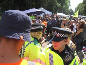 Police lines contain protestors outside the site entrance